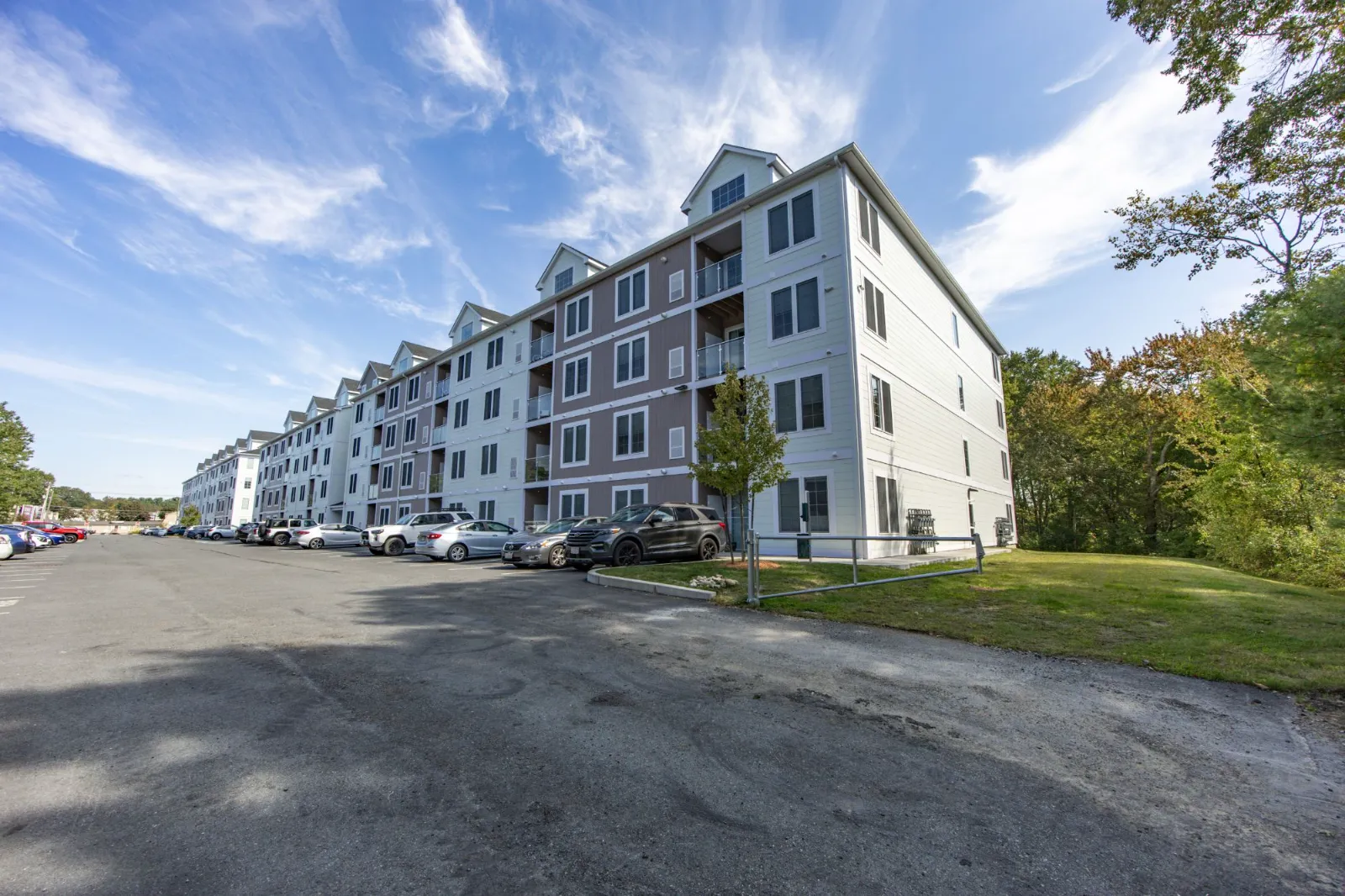 Taj Estates building exterior with resident parking